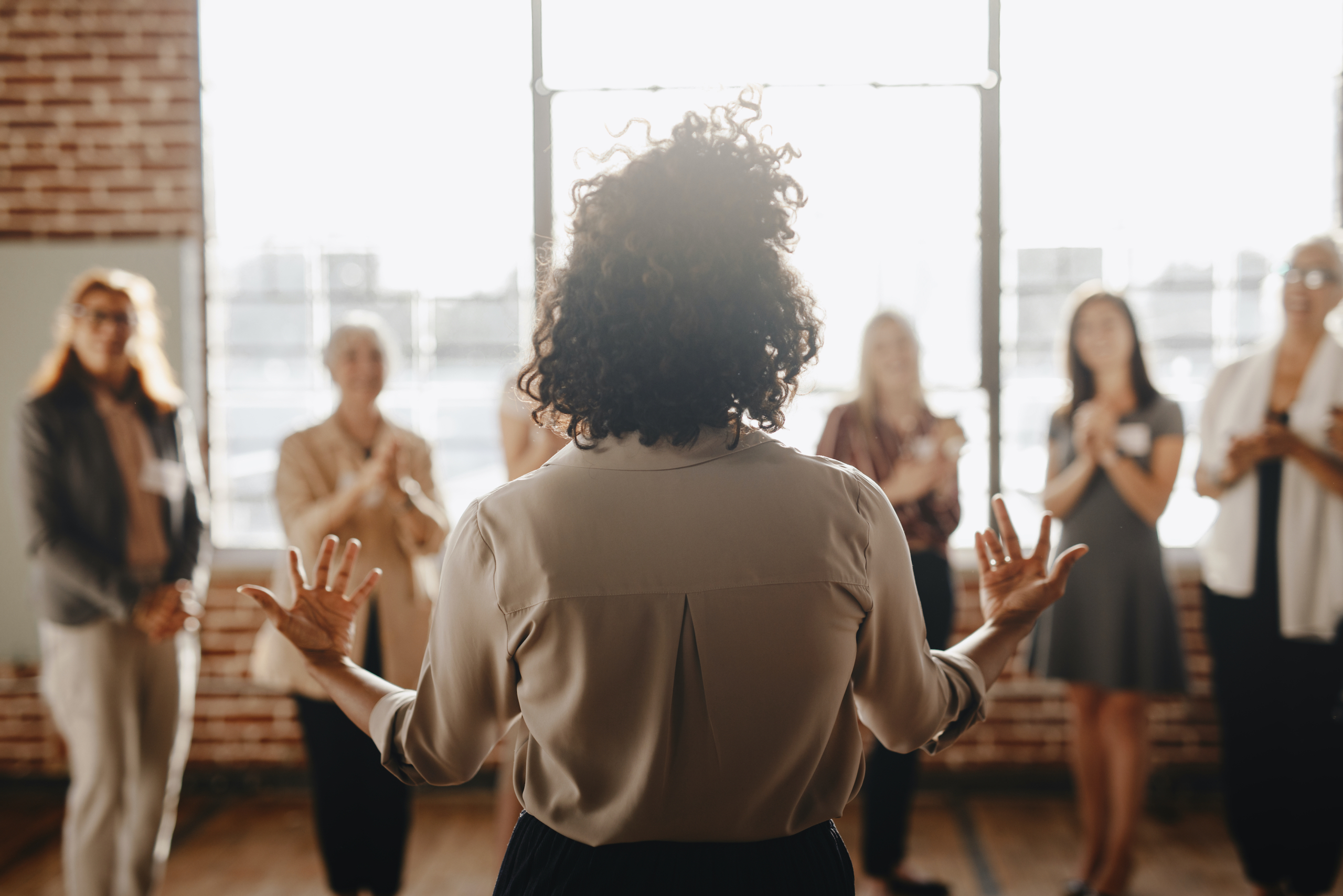 African american female empowering other colleagues in workplace