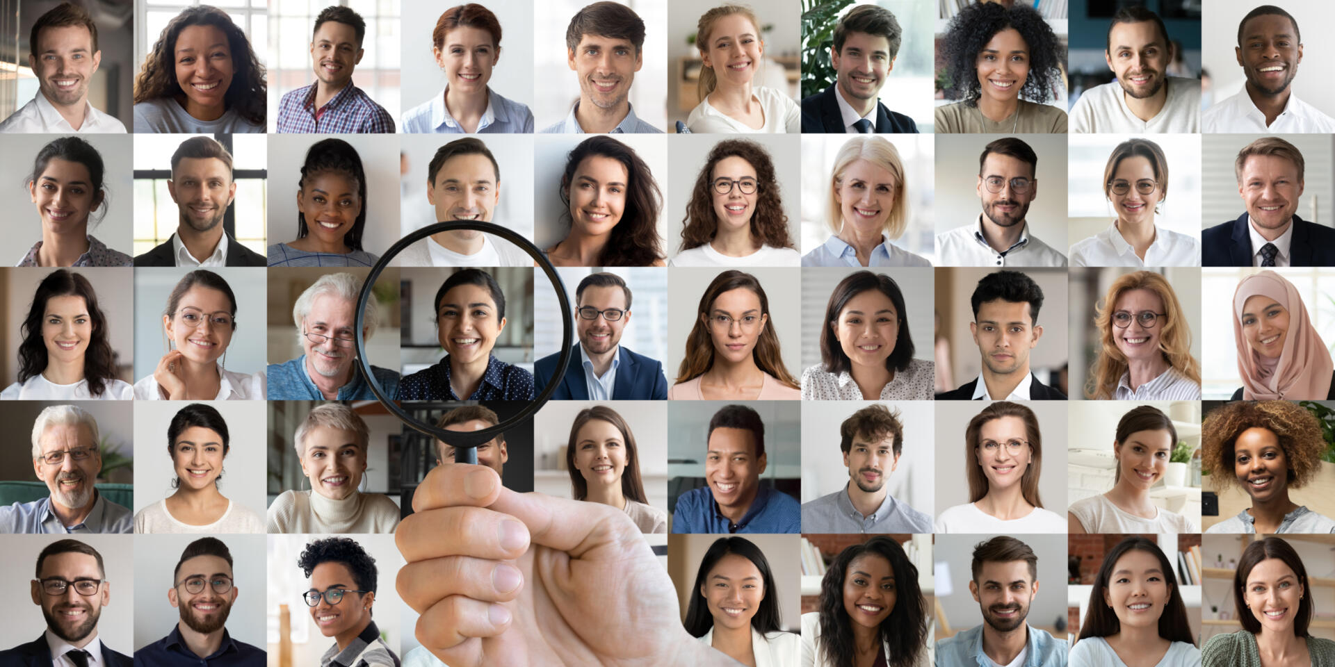 Person holding a magnifying glass up to an collection of people's headshots, stopping over one person's headshot in particular